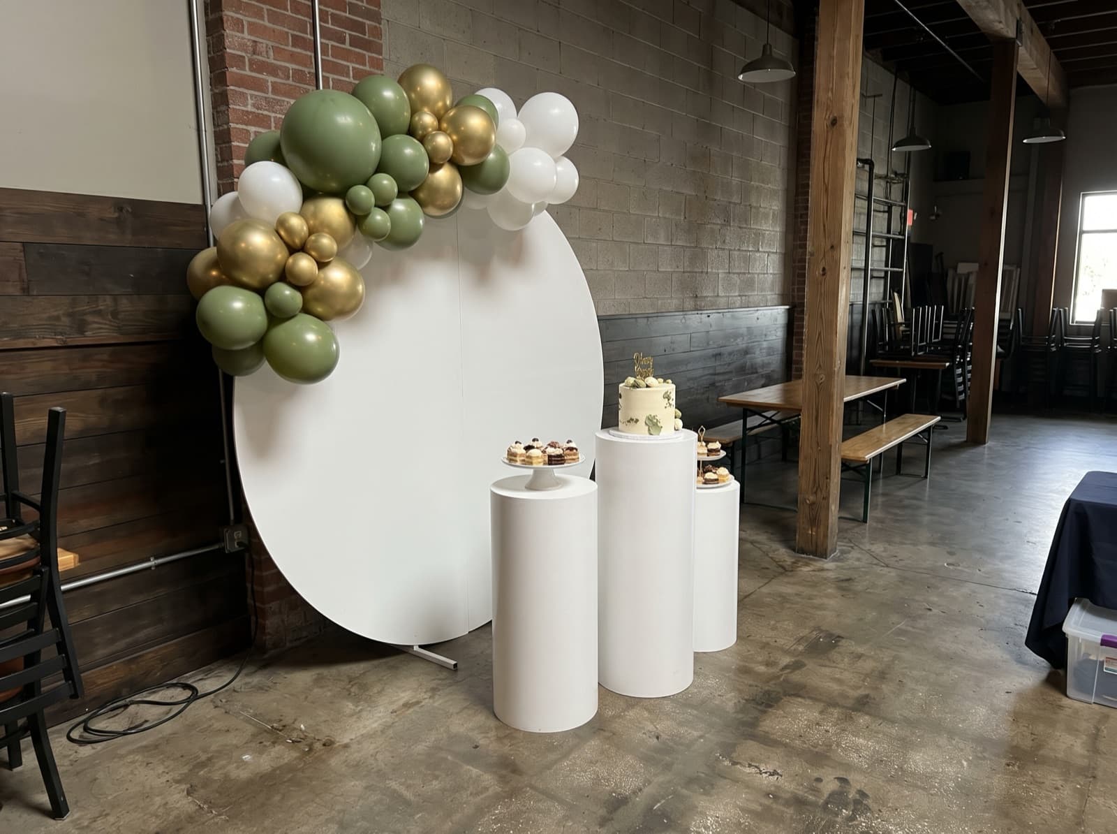 Backdrop with pedestals and a cake table