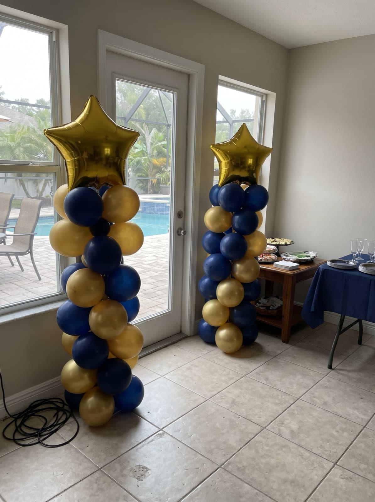 Balloon columns with gold star toppers at a graduation party