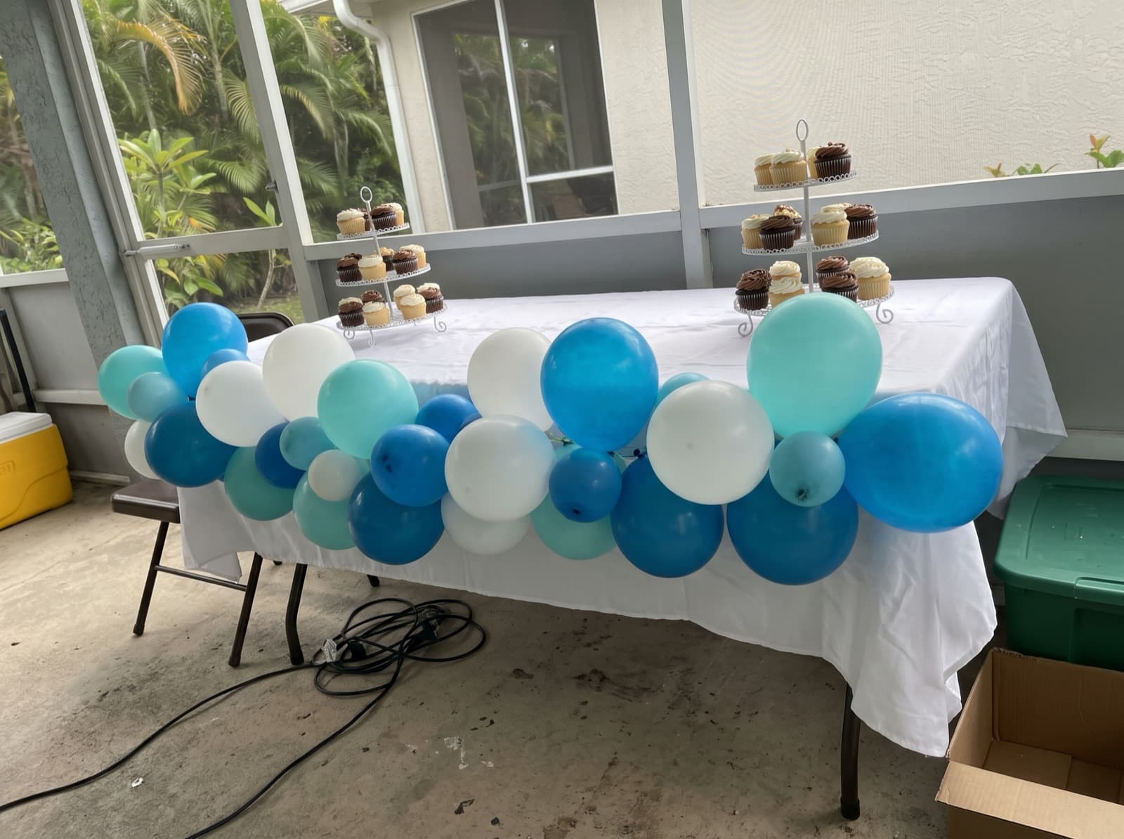 Balloon garland across the front of a cake table