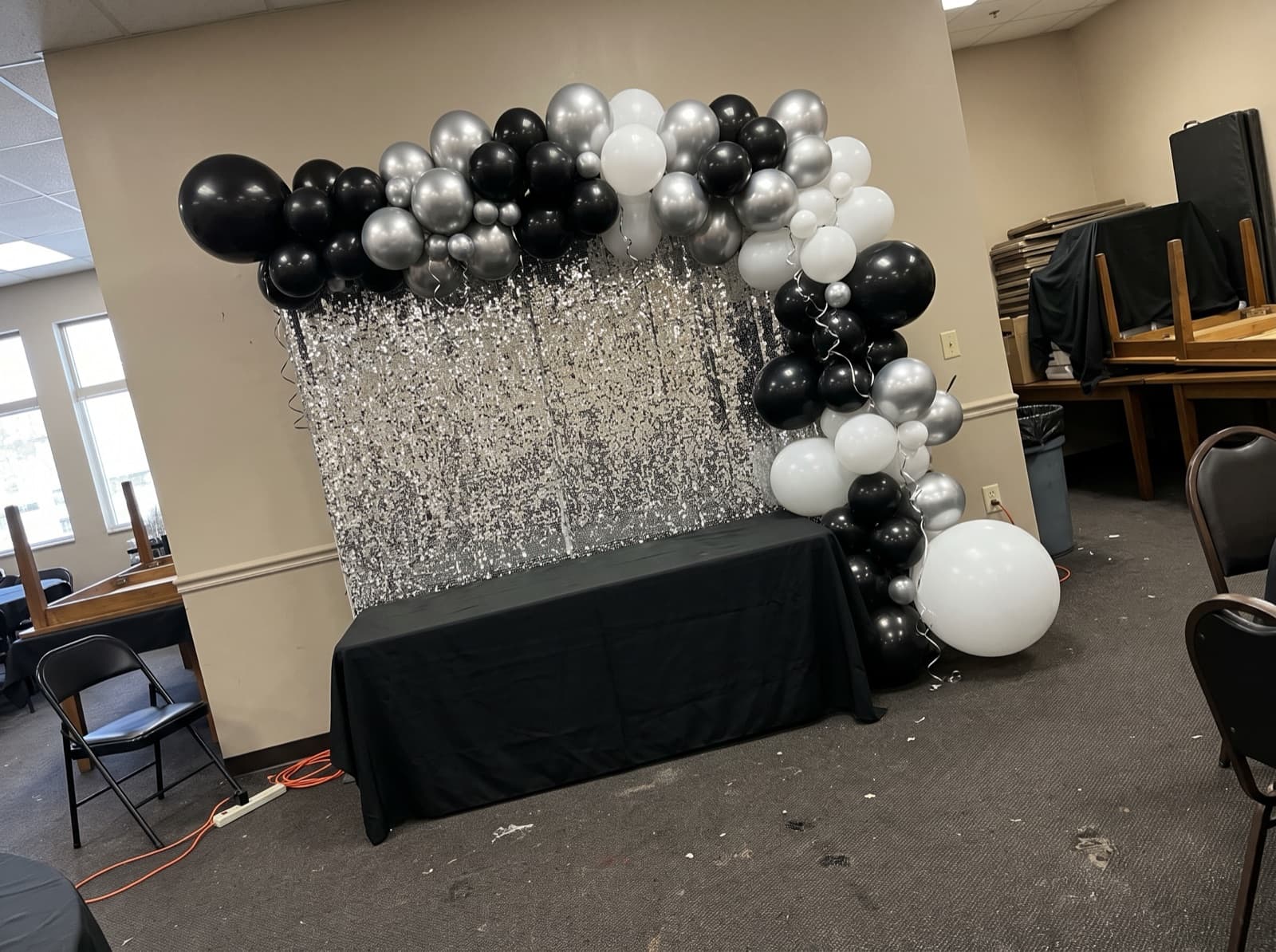Balloon garland over a silver shimmer wall