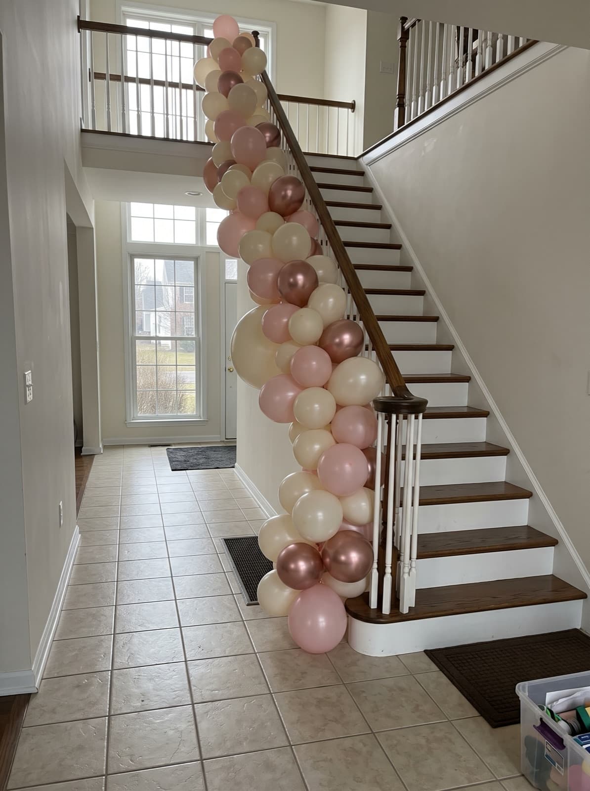 Balloon garland running down a staircase banister
