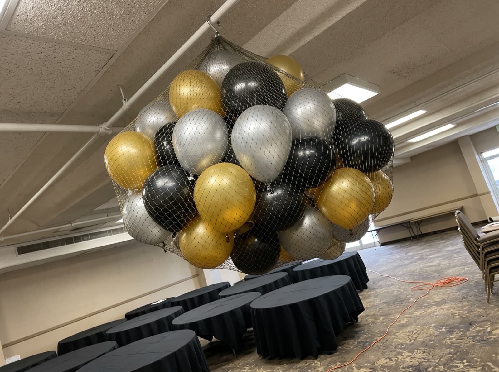 Balloon drop net overhead before a countdown
