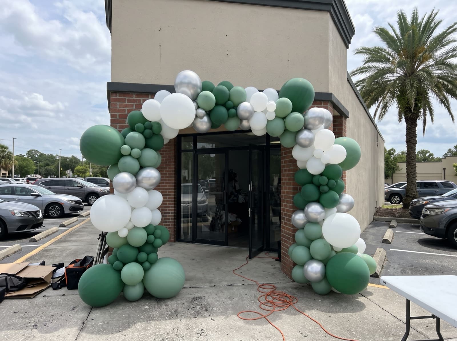 Giant balloon arch installation over a storefront